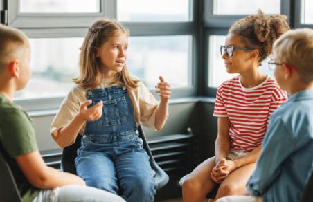 Grupo de niños sentados en círculo conversando